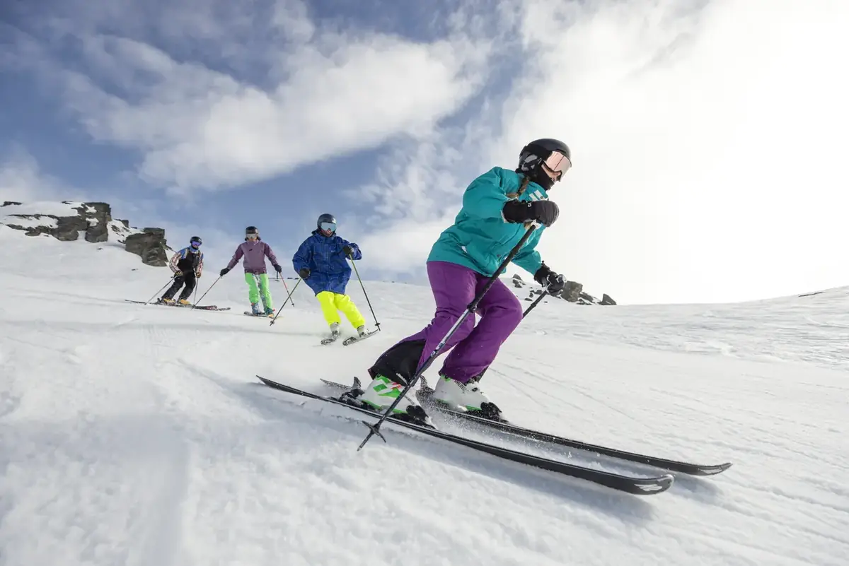 Learner skiers on a gentle slope, the classic travel insurance customer