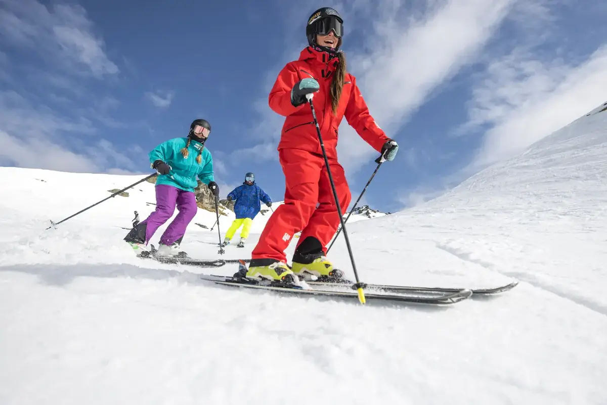 Skiers on a wide groomed run at Cardrona Alpine Resort
