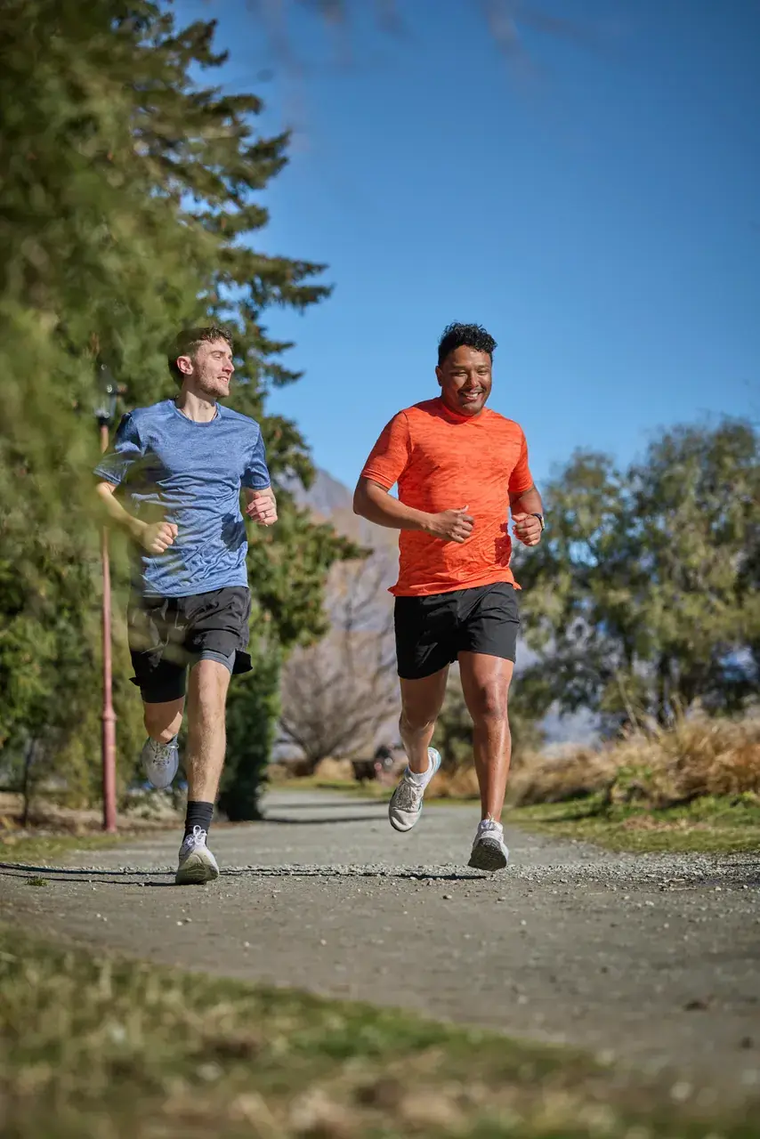 Runners on a lakeside path near Queenstown