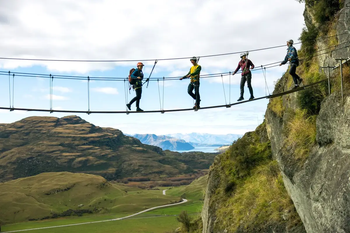 Walkers crossing a high swingbridge in the southern high country