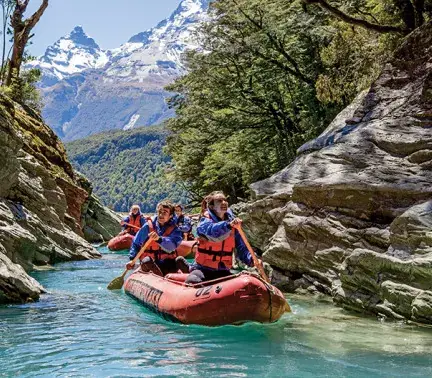 Funyaks drifting a turquoise channel of the Dart River near Glenorchy