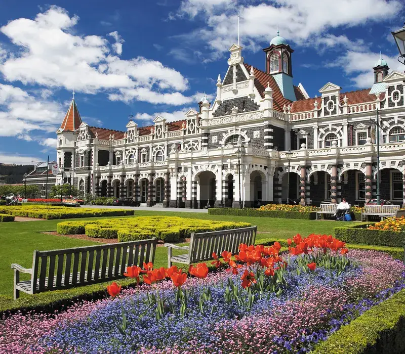 Dunedin’s ornate railway station behind its formal gardens