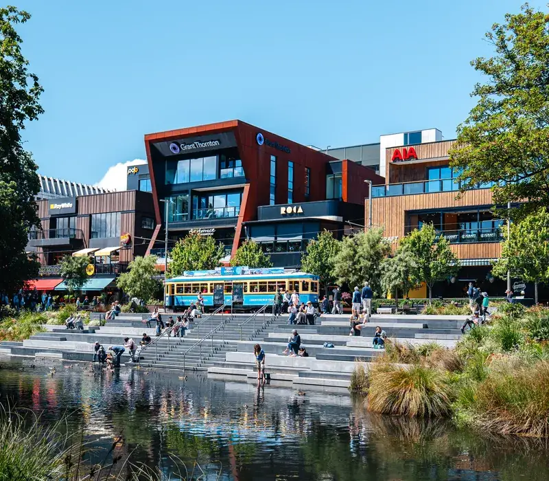 The rebuilt Avon riverfront terraces and heritage tram in central Christchurch