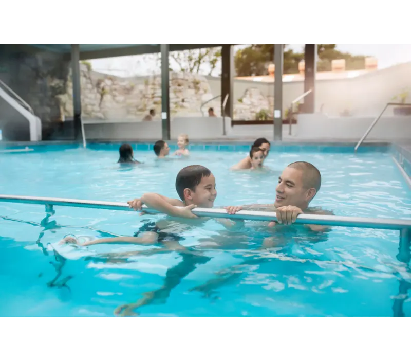 A family relaxing in the warm pools at Polynesian Spa, Rotorua